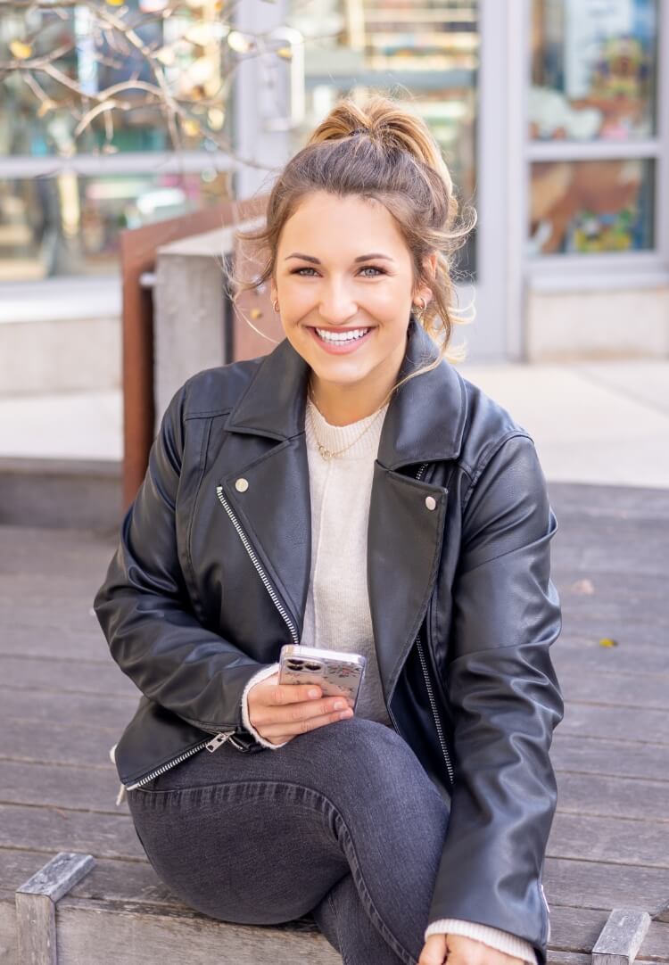 Smiling patient with a phone outside